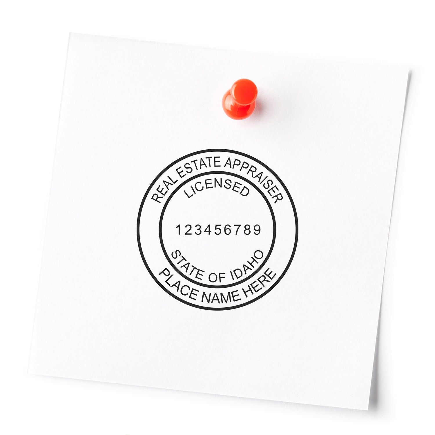 Licensed Idaho real estate appraiser seal stamped on white paper with red pin, showing certification number 123456789.