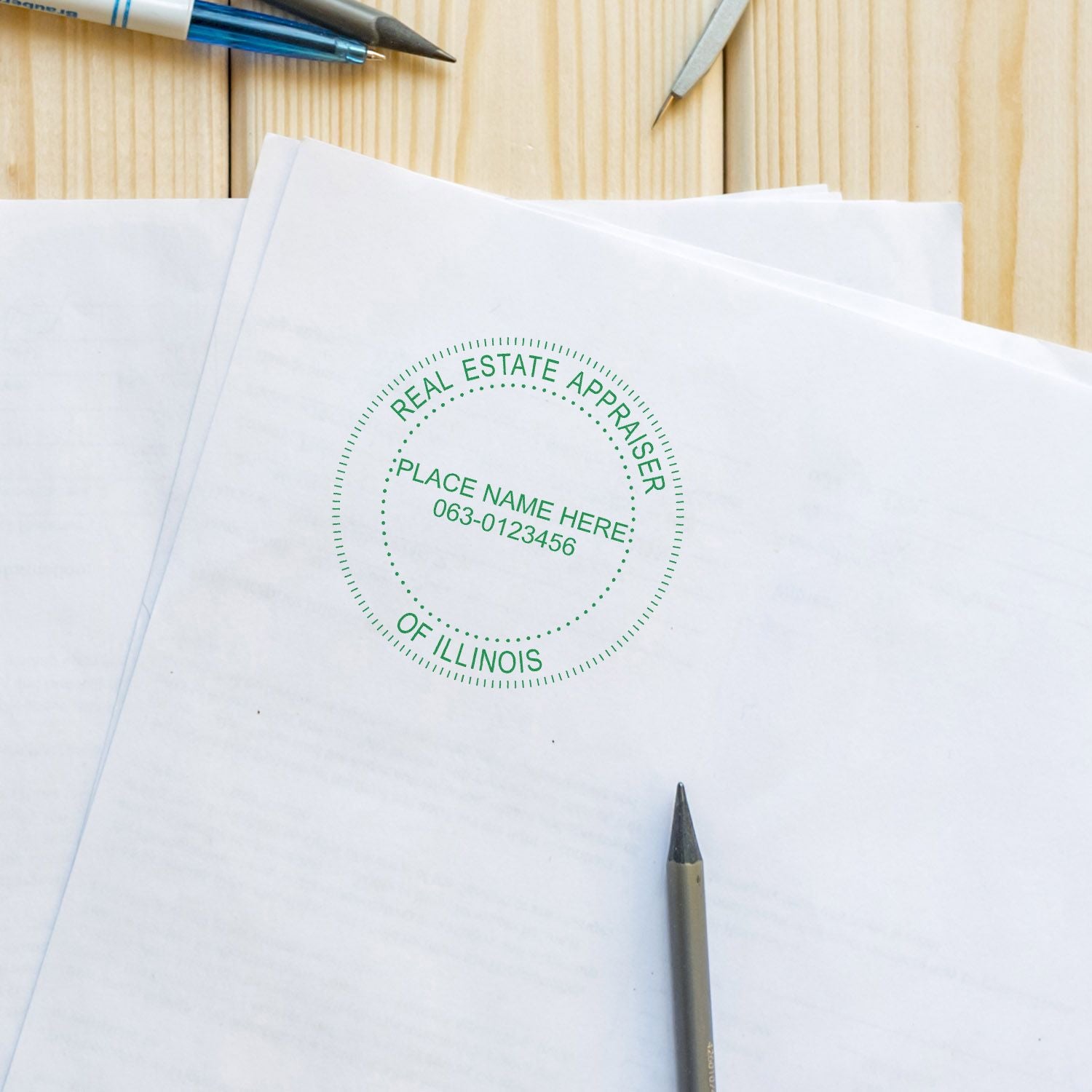 Real estate appraiser of Illinois stamp on documents with pens on a wooden desk.