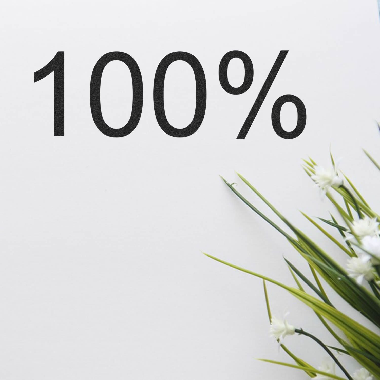 100% natural purity message on white background with fresh green grass and wildflowers, highlighting clean, sustainable products