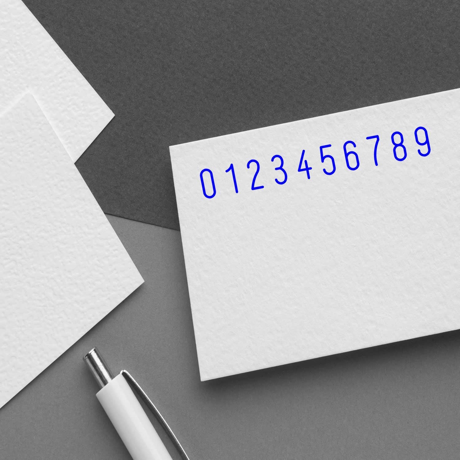 White paper with blue digits 09 printed, illustrating numeric data, coding, and math concept on a gray desk.