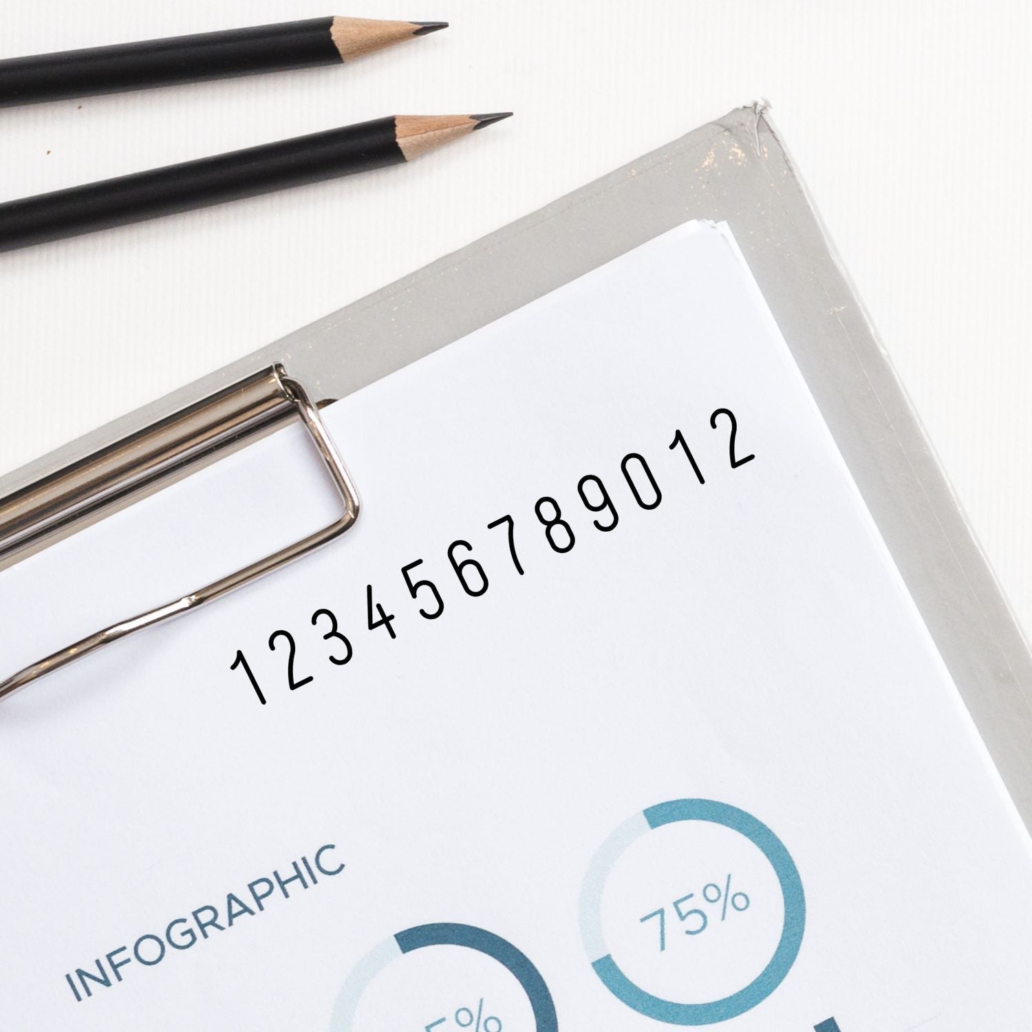 Close-up infographic sheet with handwritten numbers and pencils, showing data analysis and report design for SEO marketing insights.