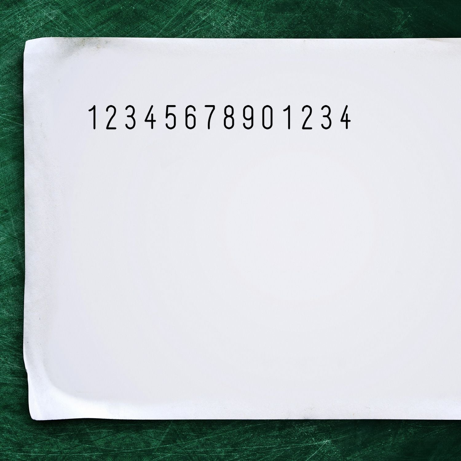 Number sequence 12345678901234 written on paper against a green chalkboard background for math practice and digit patterns