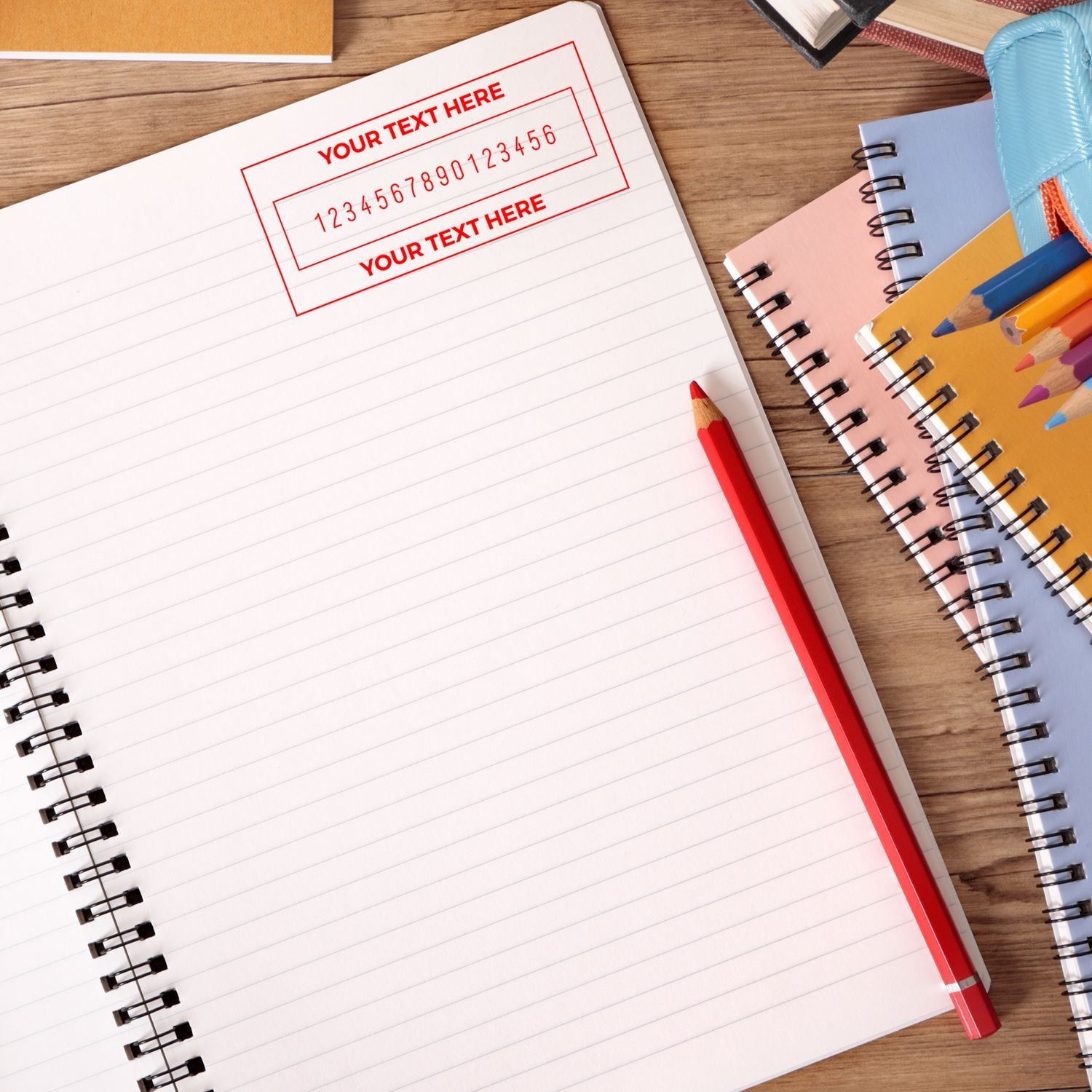 Blank notebook page template for writing, with pencils and books on a wooden deskspace for custom text.