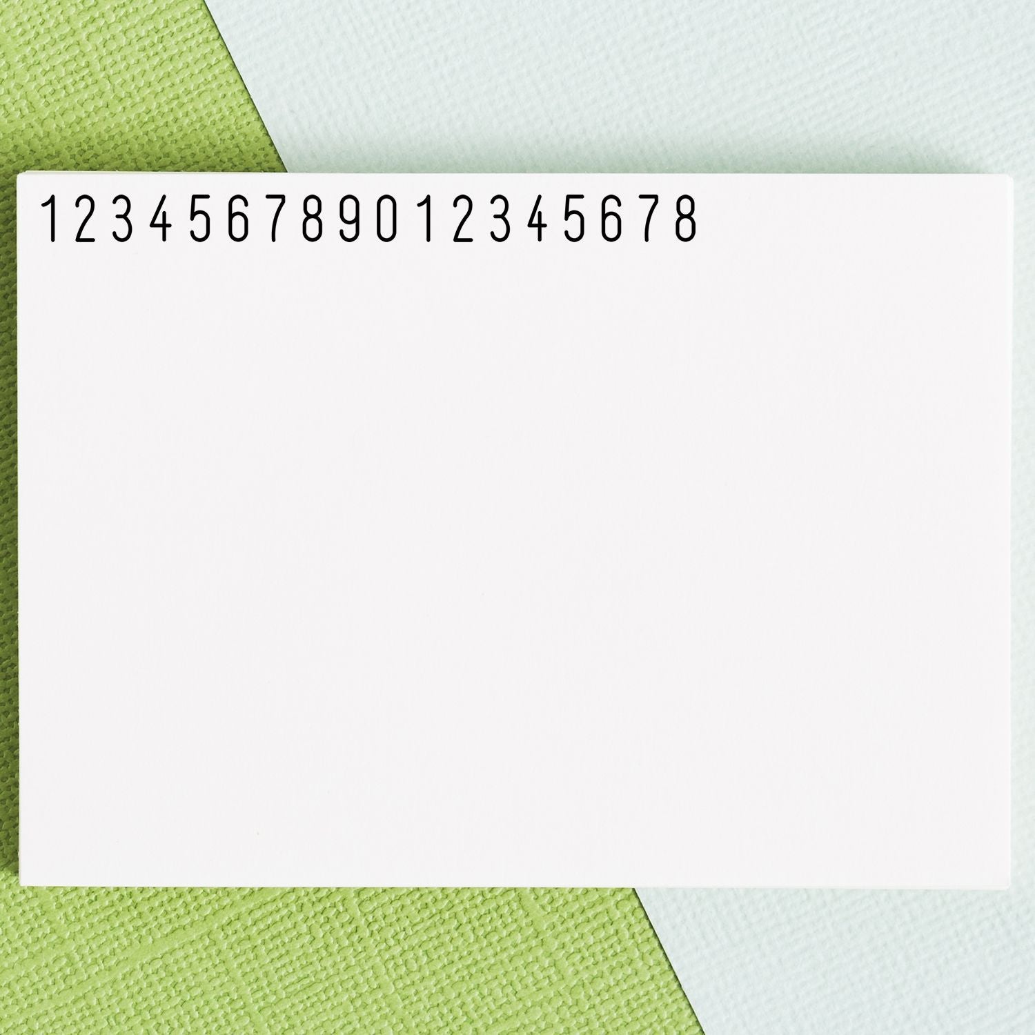 Number sequence 123456789012345678 on blank notepad card over green textured background for math and data template learning worksheet
