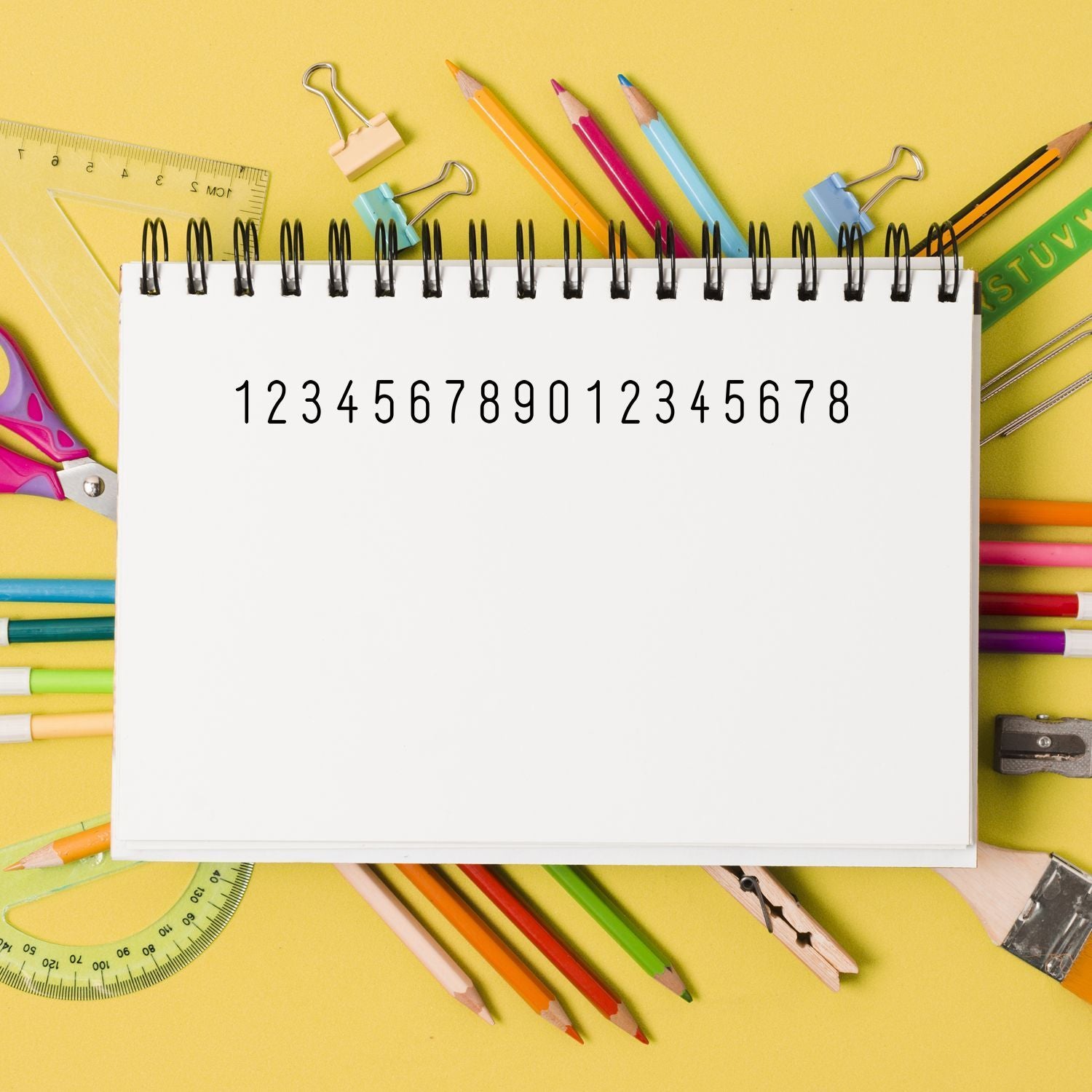 Back-to-school classroom education flat lay with blank notebook page and colorful pencils, rulers, and pens for study notes and planning