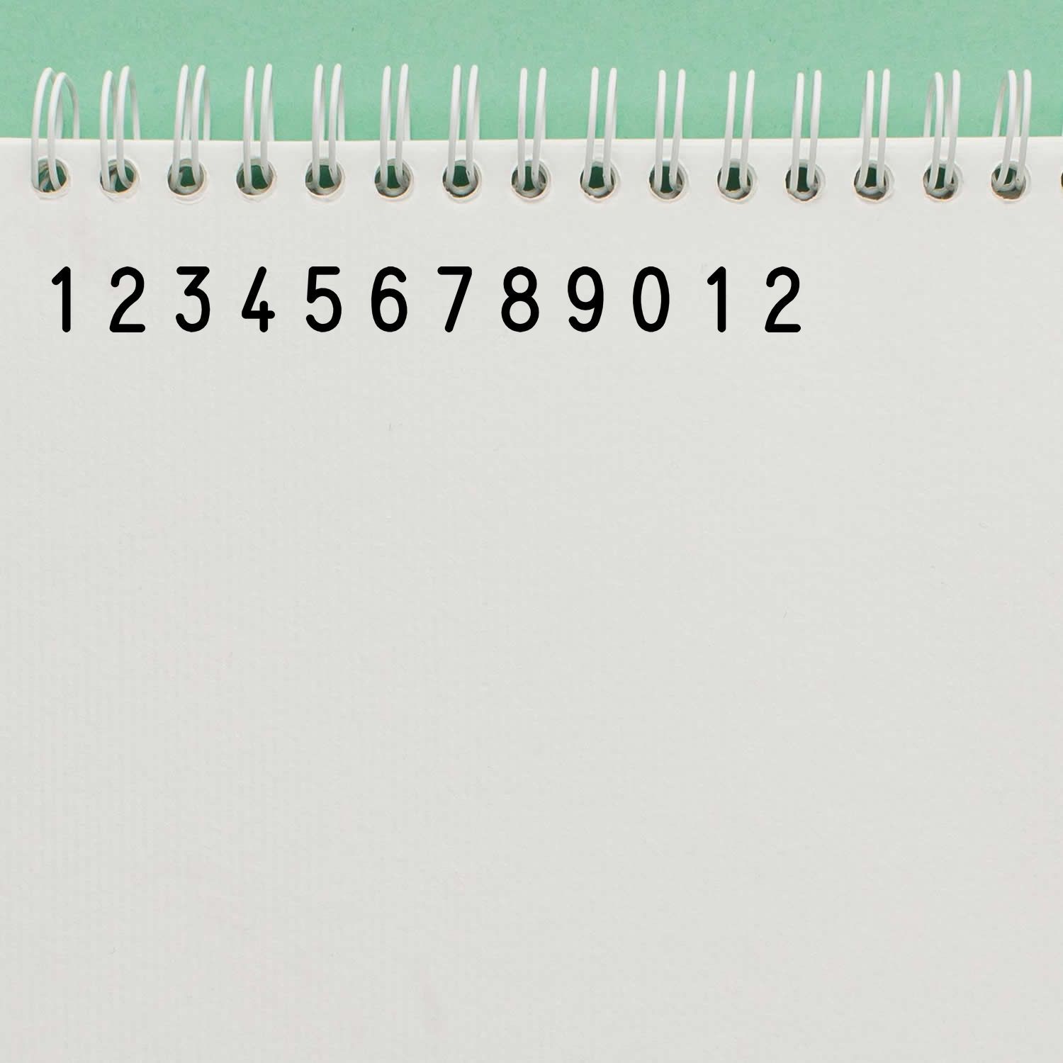 Notebook with spiral binding showing large numbers 112 for math learning, counting practice, and classroom calendar use