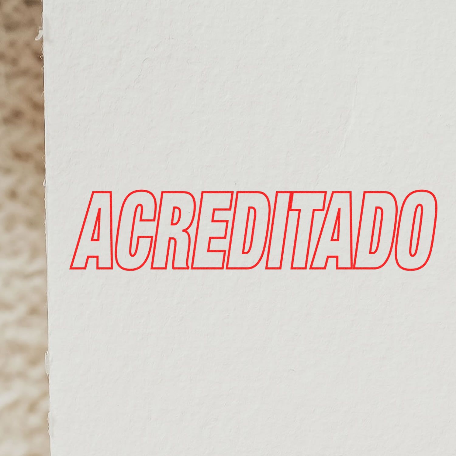 ACREDITADO red outlined letters on a white wall, showing accredited certification branding for quality assurance.