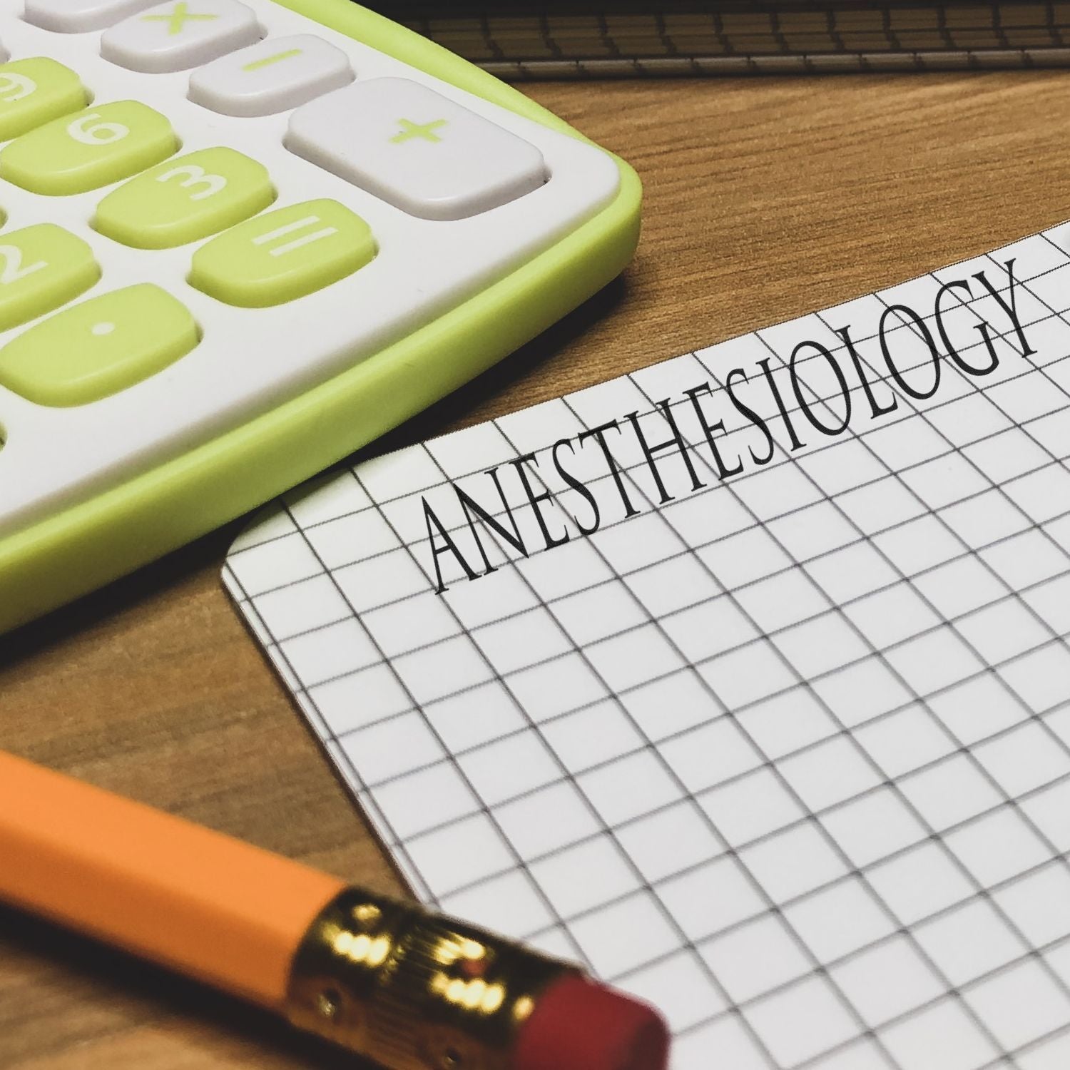 Calculator beside a grid notebook page with the word ANSWER, symbolizing math problem solving and study success.