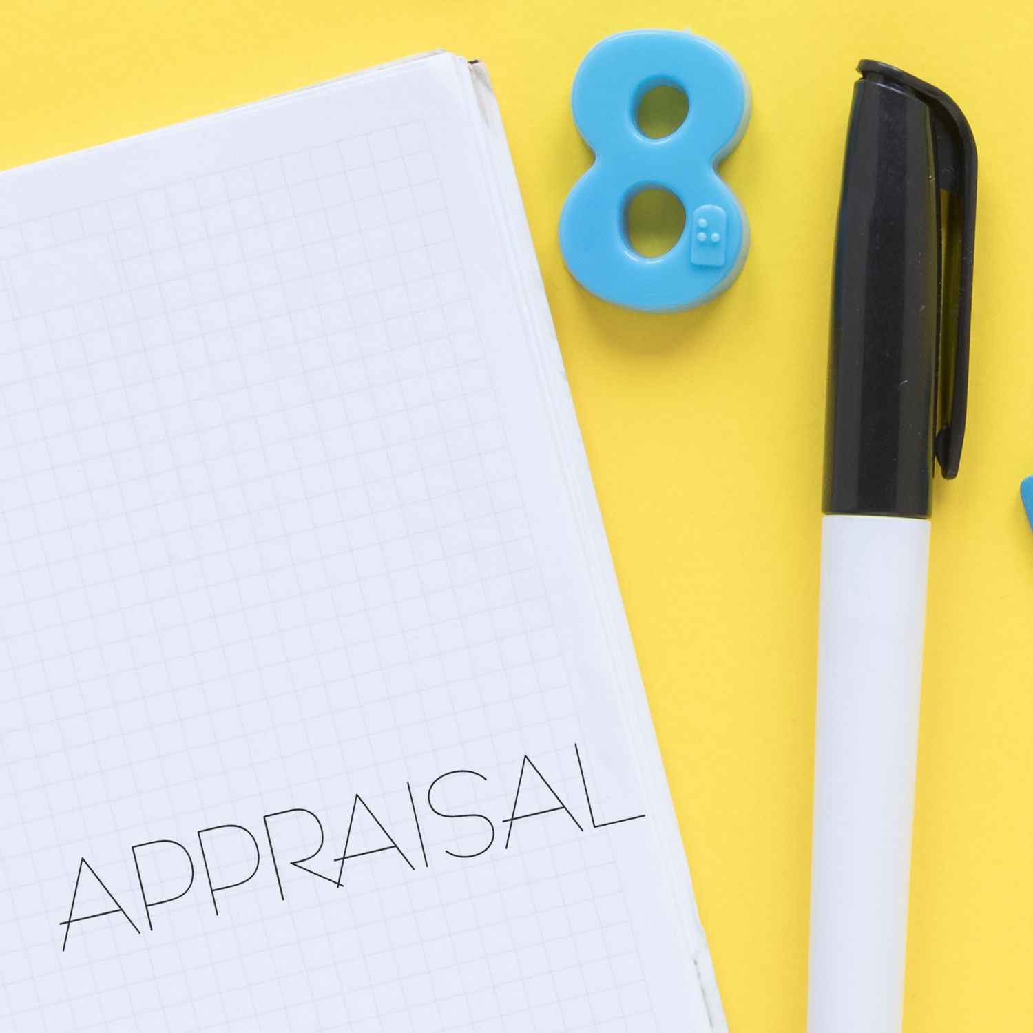 Property appraisal concept with lined notebook, black marker pen, and number 8tools for writing valuation notes.