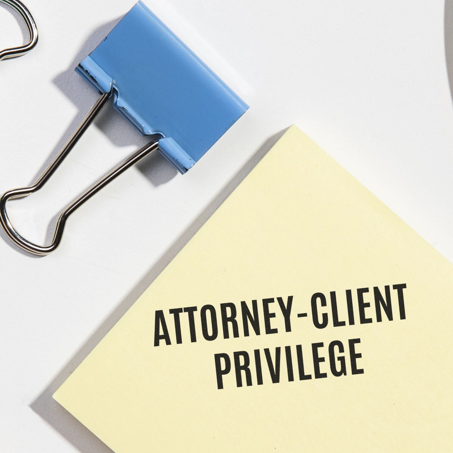 Attorney-client privilege folder clipped with binder clip, emphasizing confidential legal communications between lawyer and client.