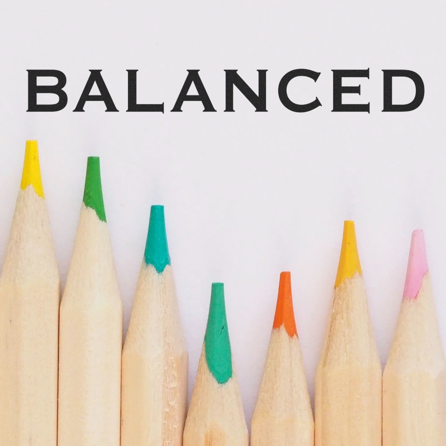 Balanced word design over colored pencil tips, promoting art education and creative writing tools on a clean white background.