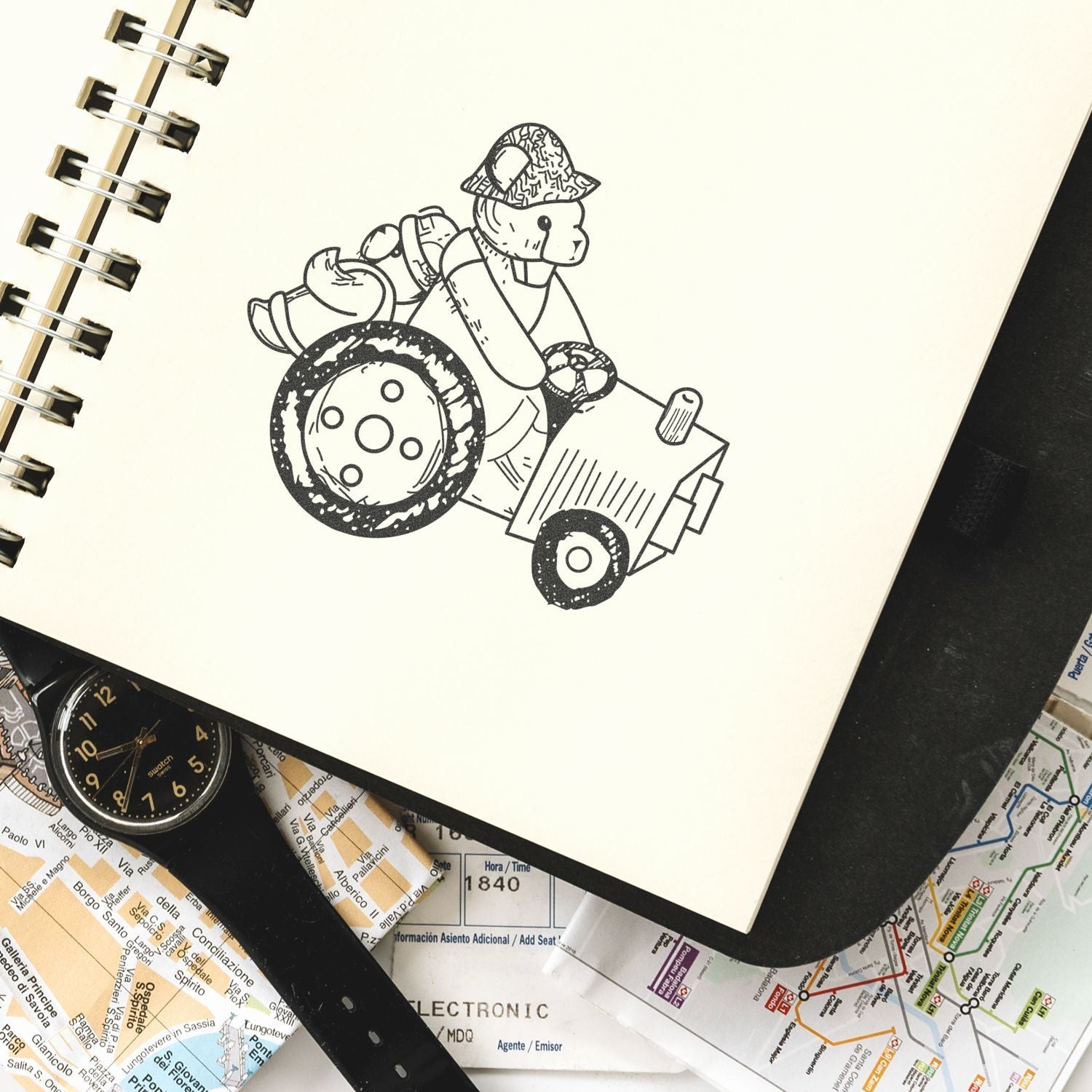 Hand-drawn dog driving a tractor in a sketchbook, surrounded by travel maps and a wristwatch.