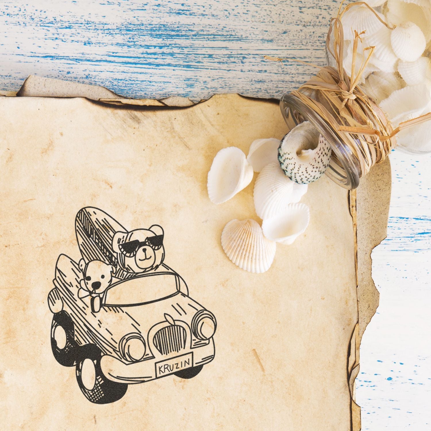 Vintage beach-themed paper background with teddy bears in a car, seashells, and rustic nautical decor on weathered wood.