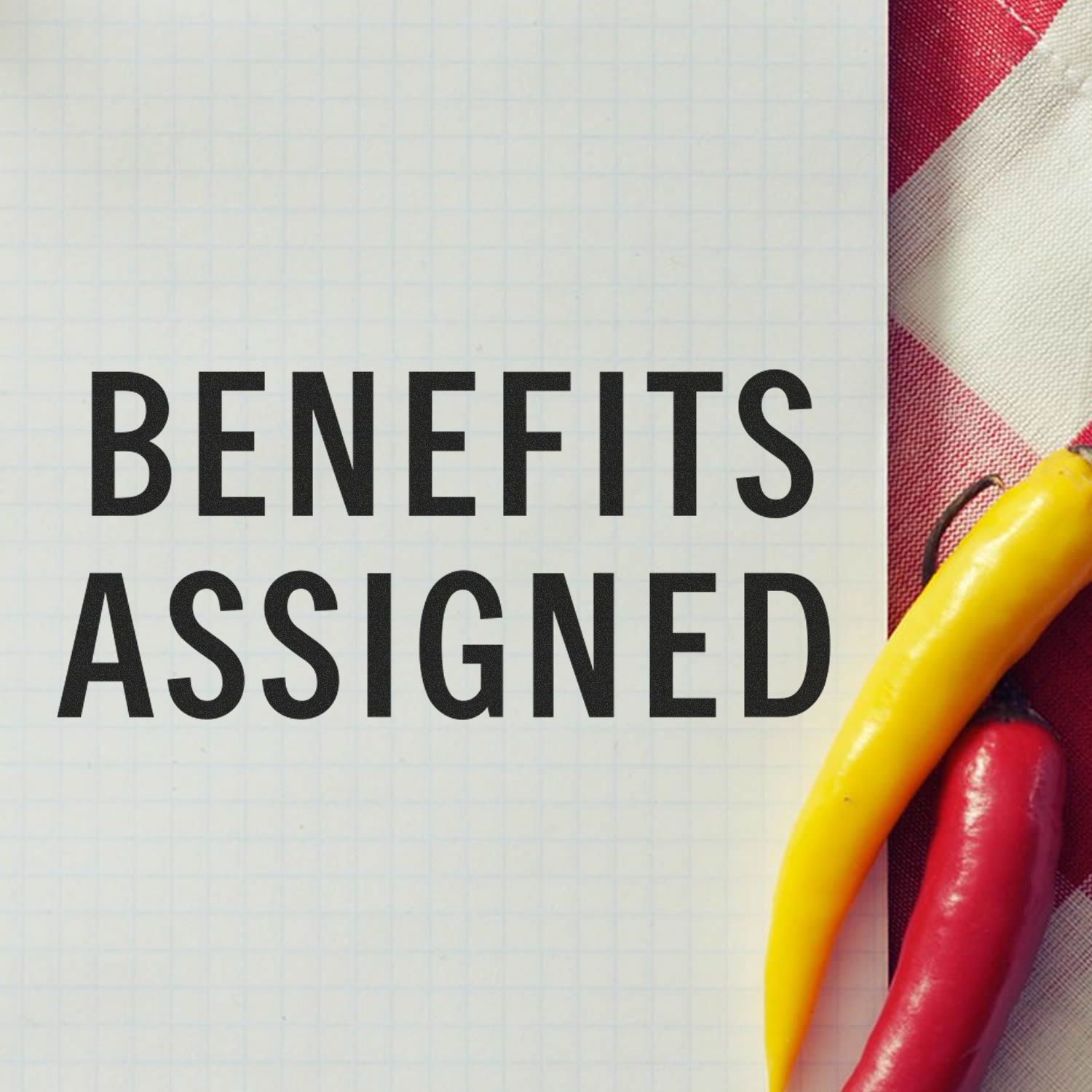 Benefits assigned headline on graph paper with yellow and red markers, promoting benefits management and goal setting concept ideas.