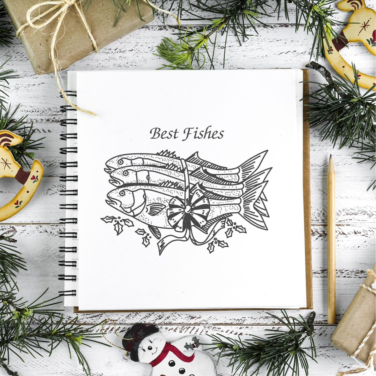 Holiday greeting card design with Best Fishes fish illustration in a festive Christmas flat lay scene
