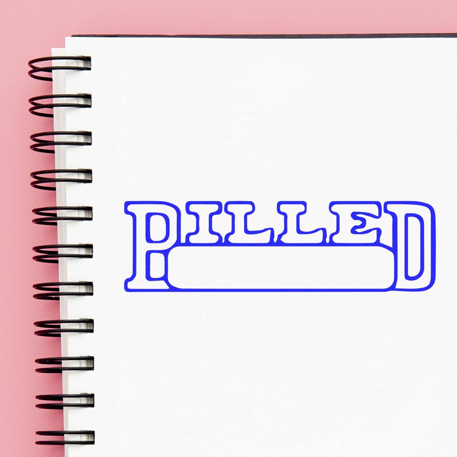 Spiral notebook with blank page and blue stylized typography, conveying journaling, study notes, and planning.