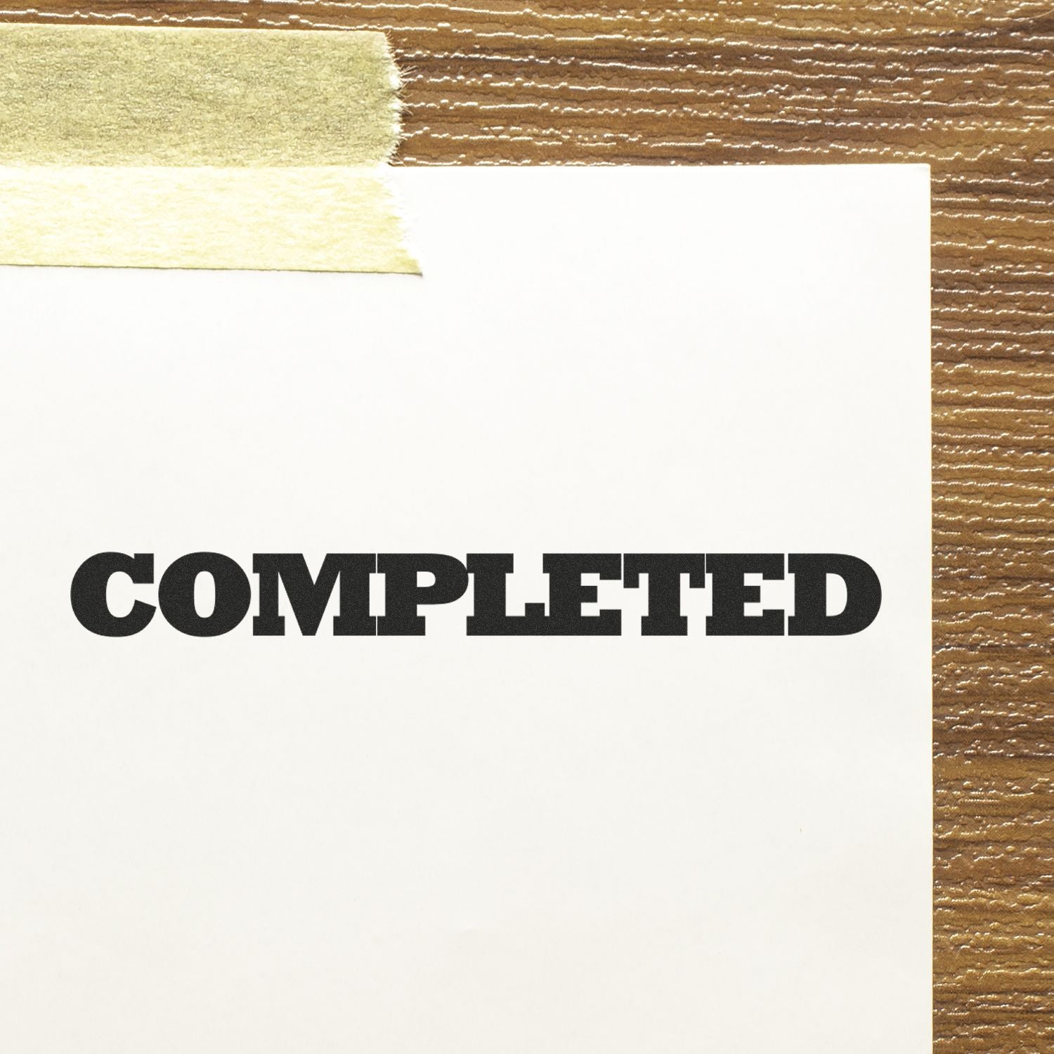 Close-up of 'COMPILETED' printed label on a white card over wood-grain background, signaling project completion and finished status.