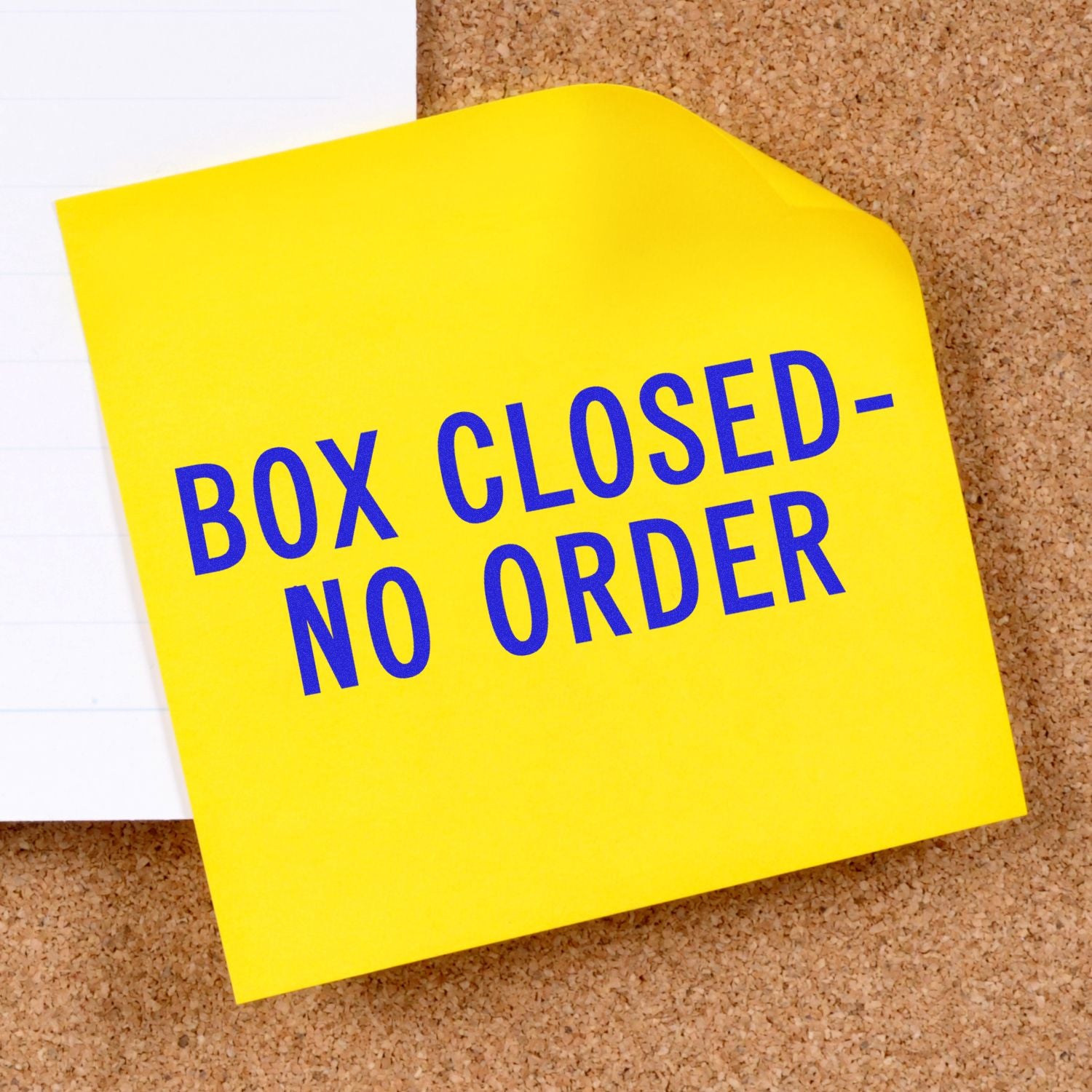 Yellow note on cork board reading Box Closed, No Order, signaling completed shipping and no pending customer order.