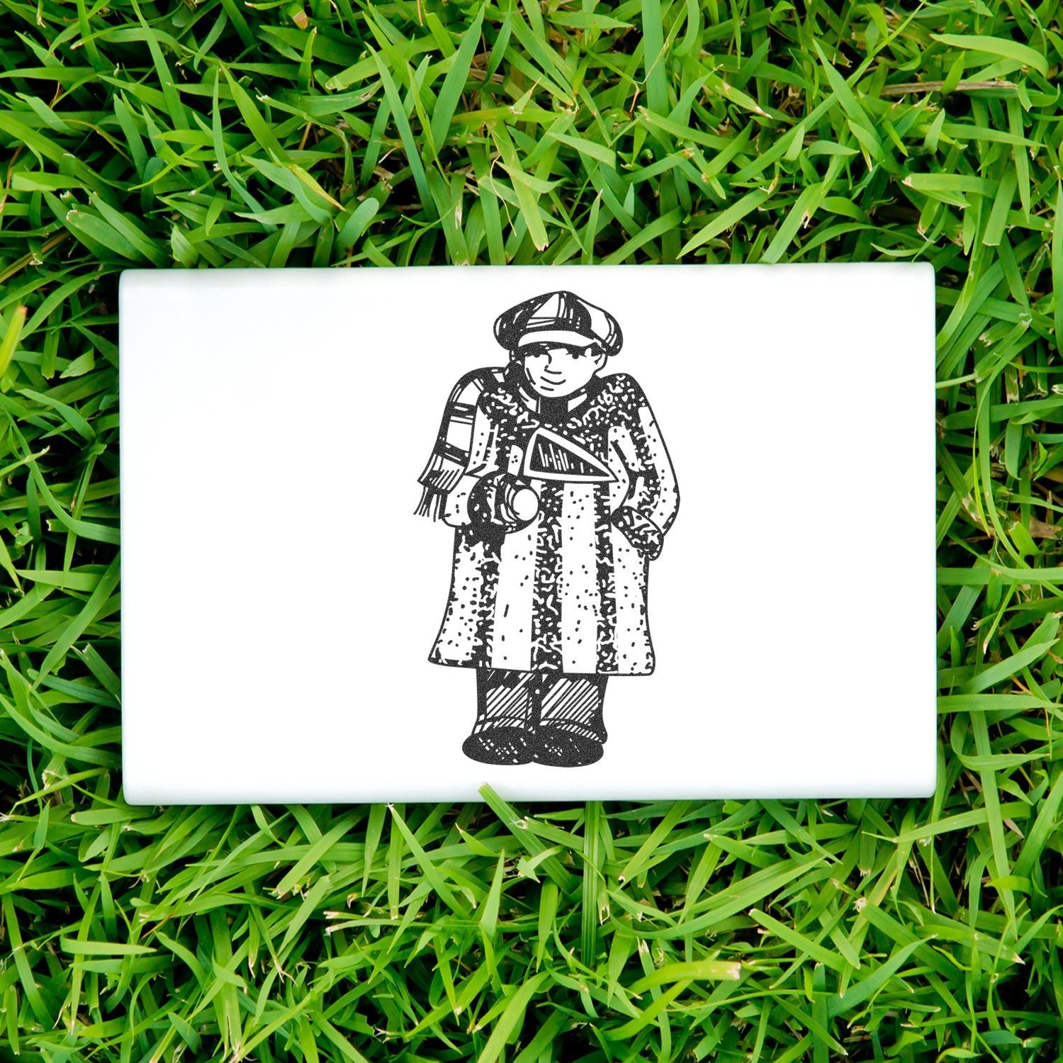 White ceramic tile with a black vintage-style illustration of a person in traditional clothing on green grass.