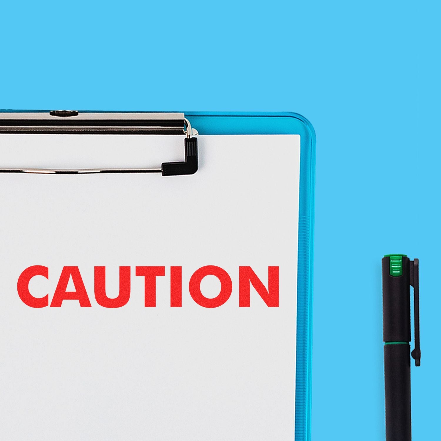 Close-up of clipboard with red CAUTION warning text and marker pen on blue background.