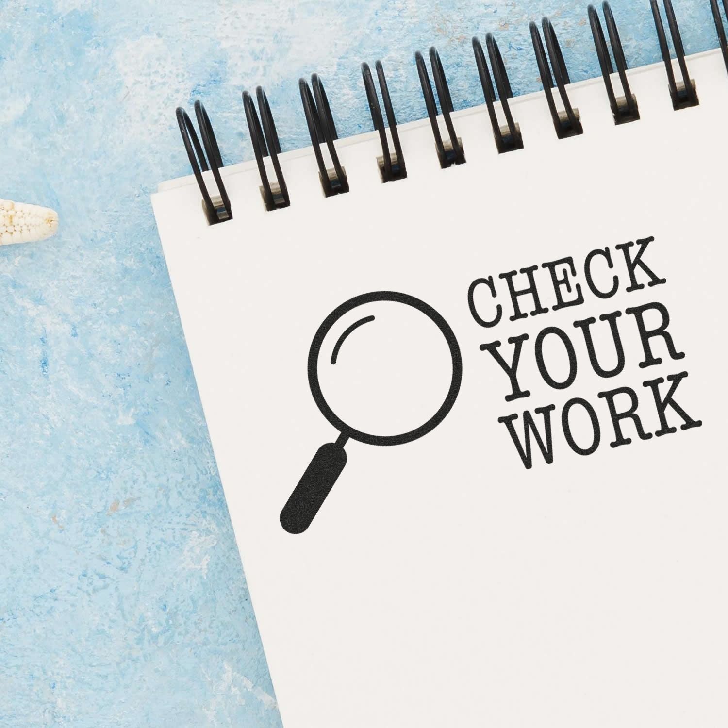 Clipboard checklist graphic with magnifying glass reading Check Your Work! for proofreading, editing, and quality control.