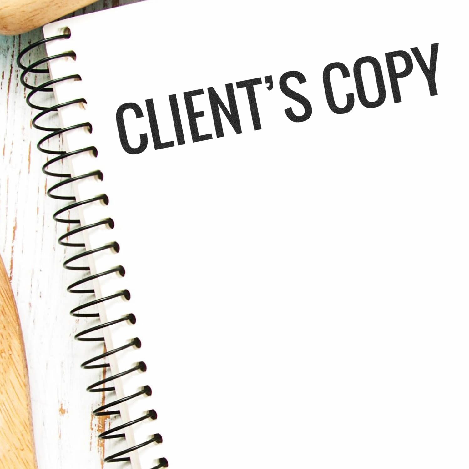 Clients copy text on a spiral notebook page, indicating a delivered contract or document copy for the client.