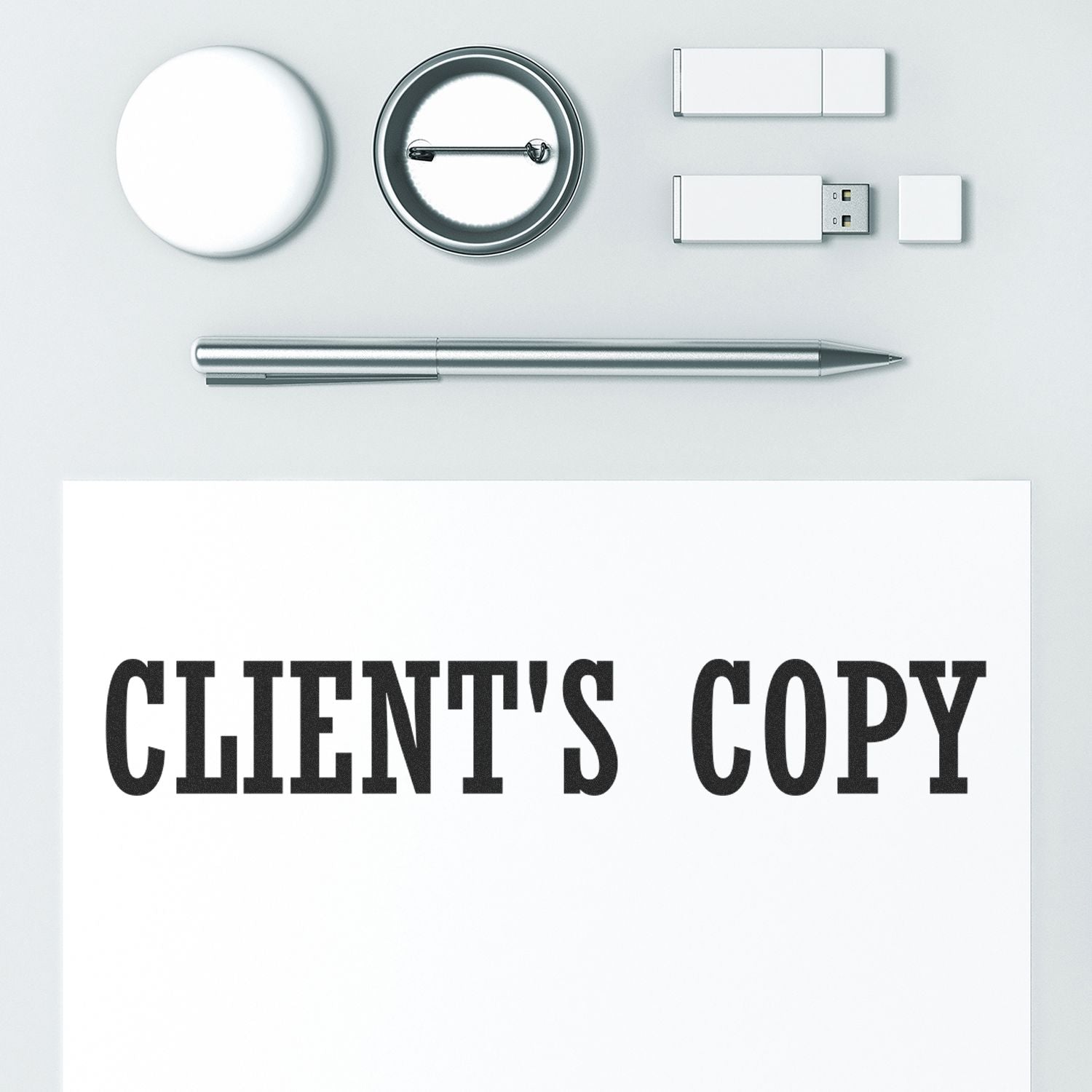 Minimalist office flat lay showing pen, magnifying glass, USB drives, and Clients Copy text for business document design SEO.