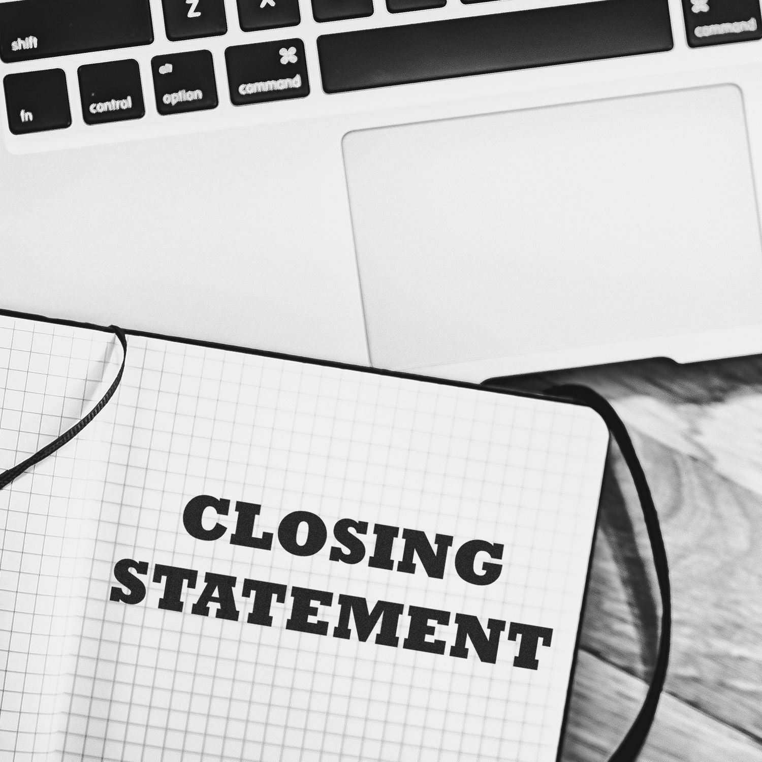 Closing statement written in notebook beside laptop keyboard, legal or business presentation concept.
