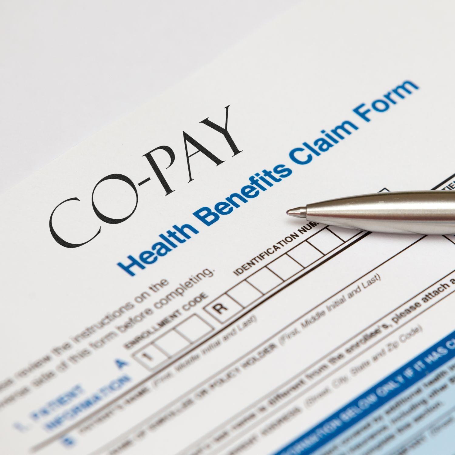 Health benefits claim form with CO compliance and pen, illustrating healthcare insurance documentation and claim processing.