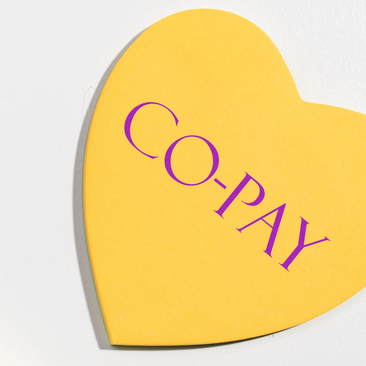 Yellow heart with purple AI and magnifying-glass icon, symbolizing artificial intelligence and research.