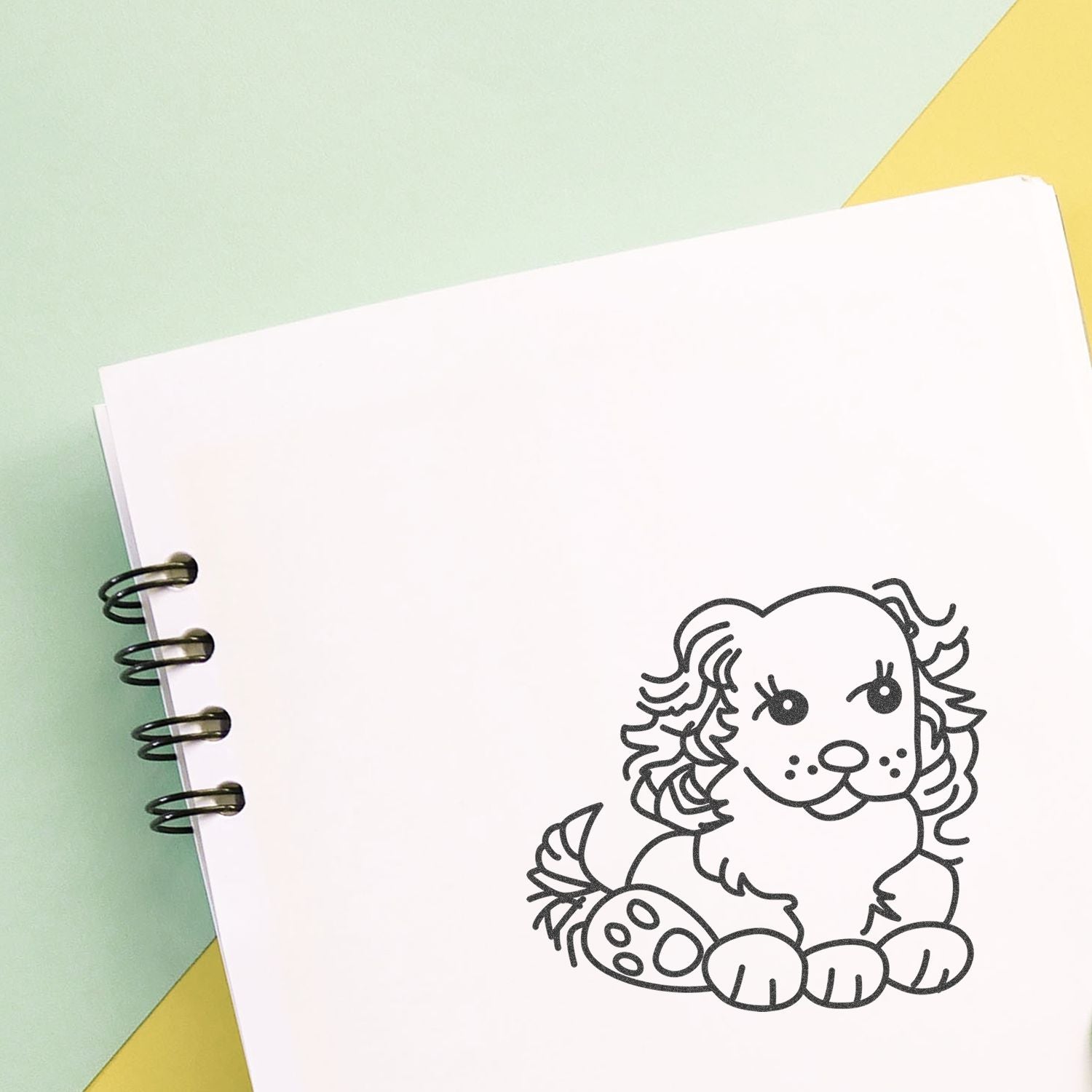 Spiral notebook with blank page and cute puppy illustration on pastel background.