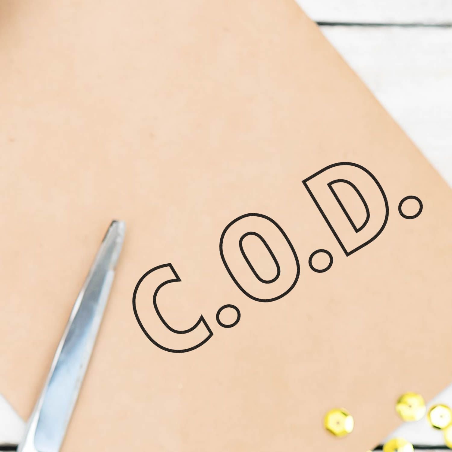 Close-up of branded notebook cover with black logo, pen edge, and yellow beads for office workspace branding design