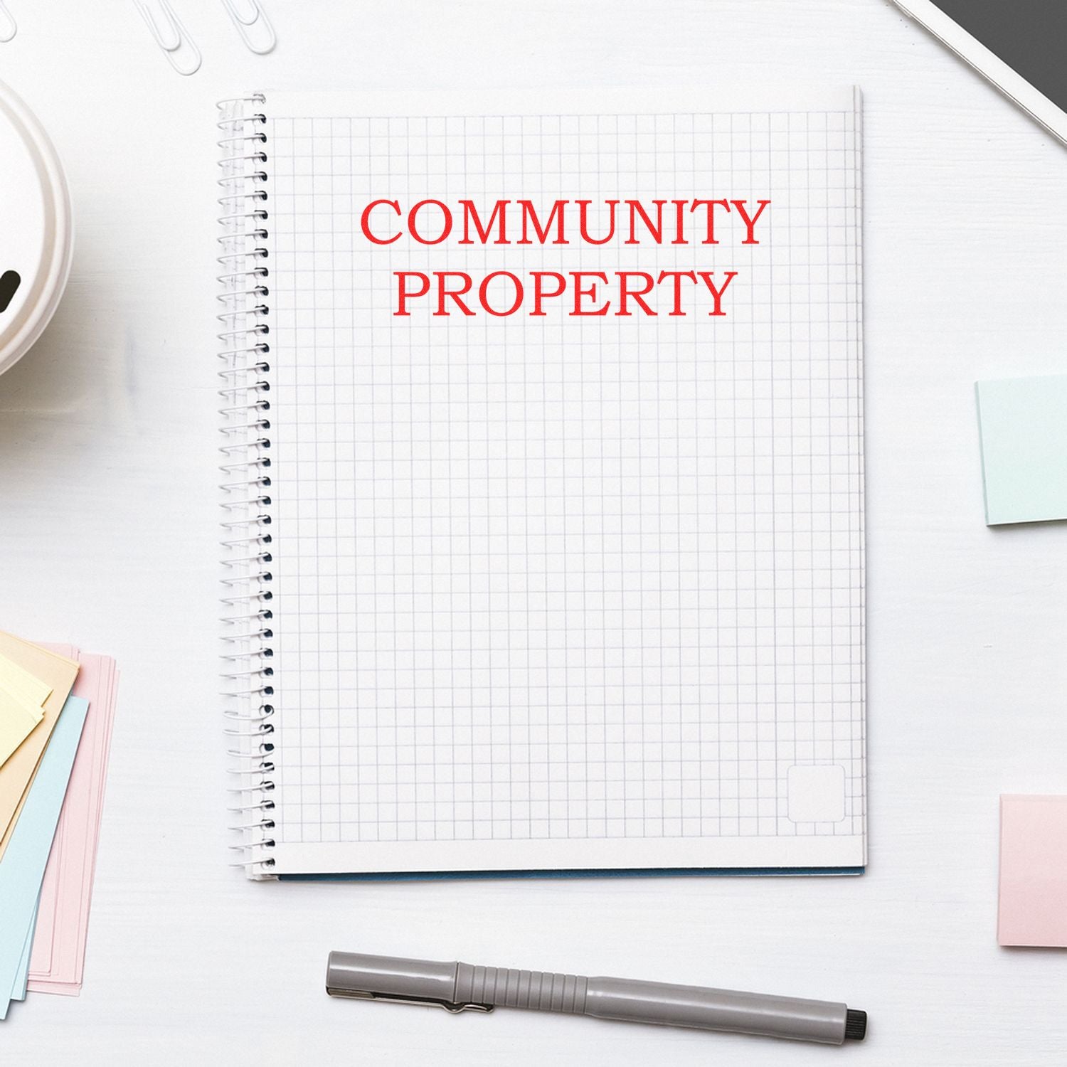 Notebook on desk with bold Community Property text, illustrating real estate legal ownership rights.