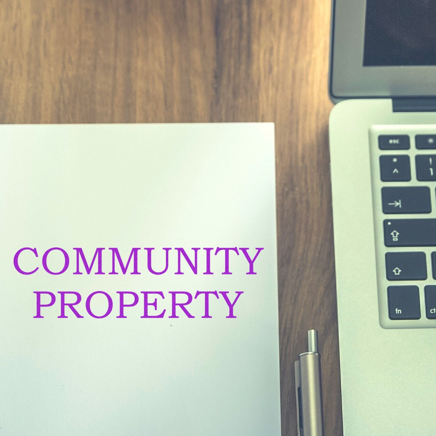 Community Property legal document with laptop and pen on desk, promoting community property law and real estate guidance tips.