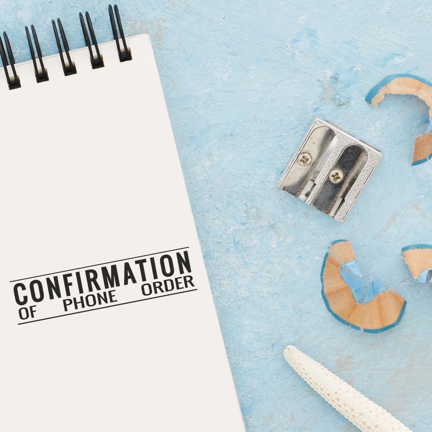 Wall phone jack and confirmation phone order note on blue plasterillustrating phone ordering and customer support.