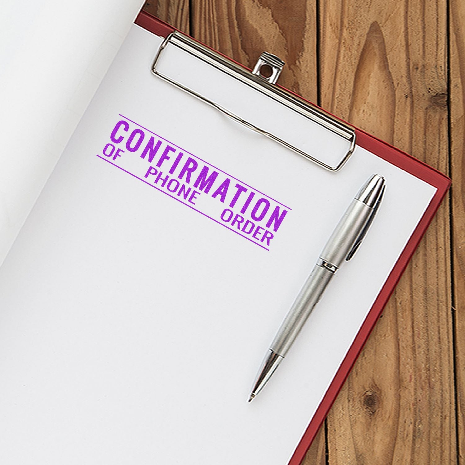 Clipboard with confirmation of phone order form and pen on wooden desk, business order confirmation concept.