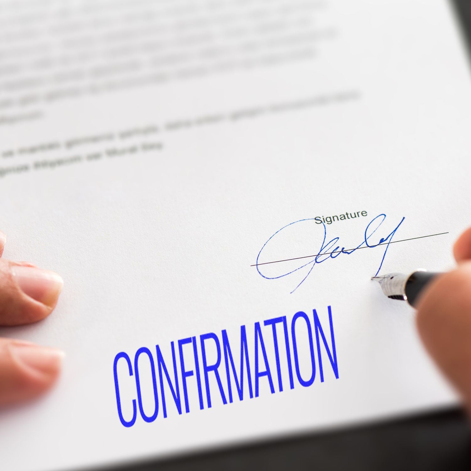 Person signing a confirmation contract document with blue signature line, showing legal agreement and document approval.