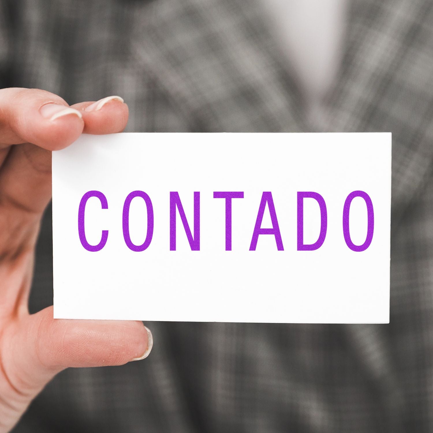 Hand holding a Contact card with purple text, showing how to reach out or get in touch.