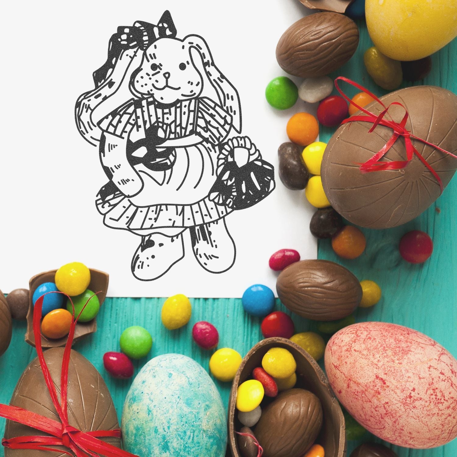 Easter bunny coloring page surrounded by chocolate eggs and colorful candy on a turquoise background