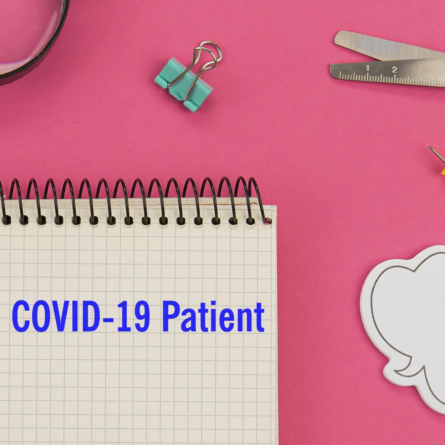 COVID-19 patient care concept with notebook, stationery and mask on pink background, highlighting pandemic health awareness.