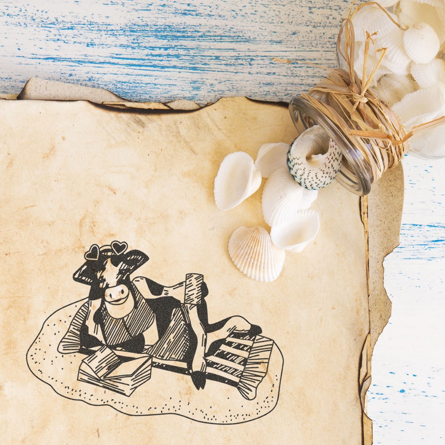Vintage beach scrapbook background with seashells, rustic paper, and a cute cow illustration