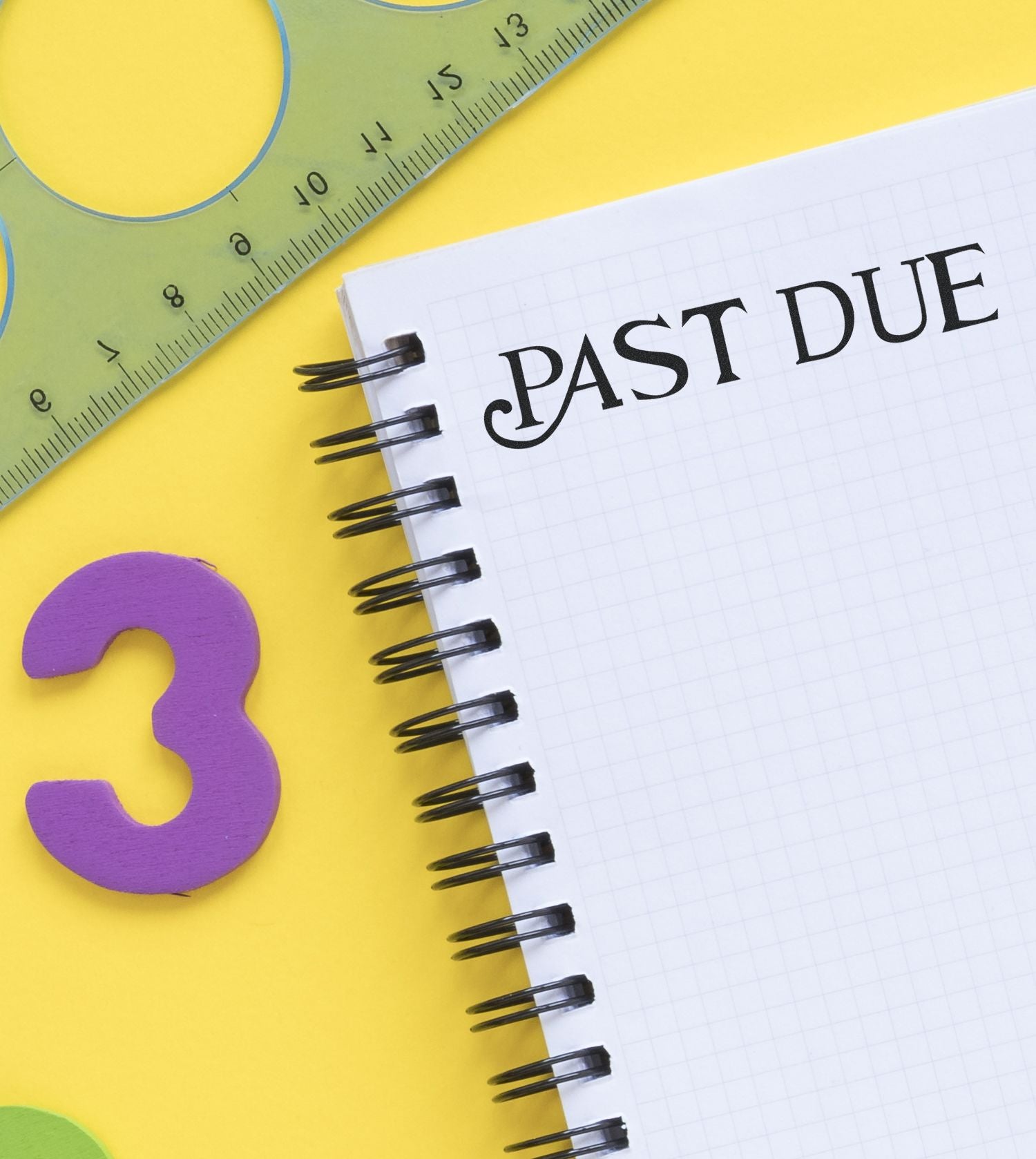 Past due notebook reminder with ruler and colorful school supplies on yellow background.