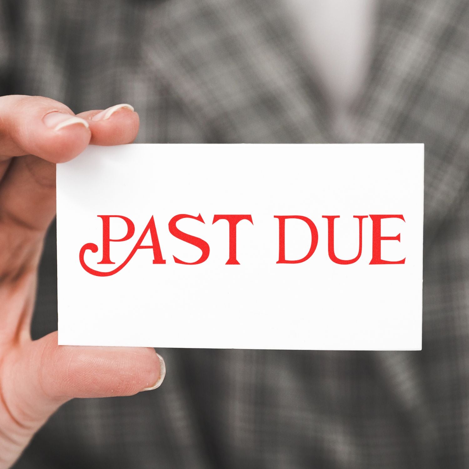 Hand holding a Past Due notice card, symbolizing overdue payment and late invoice reminder for accounts receivable.