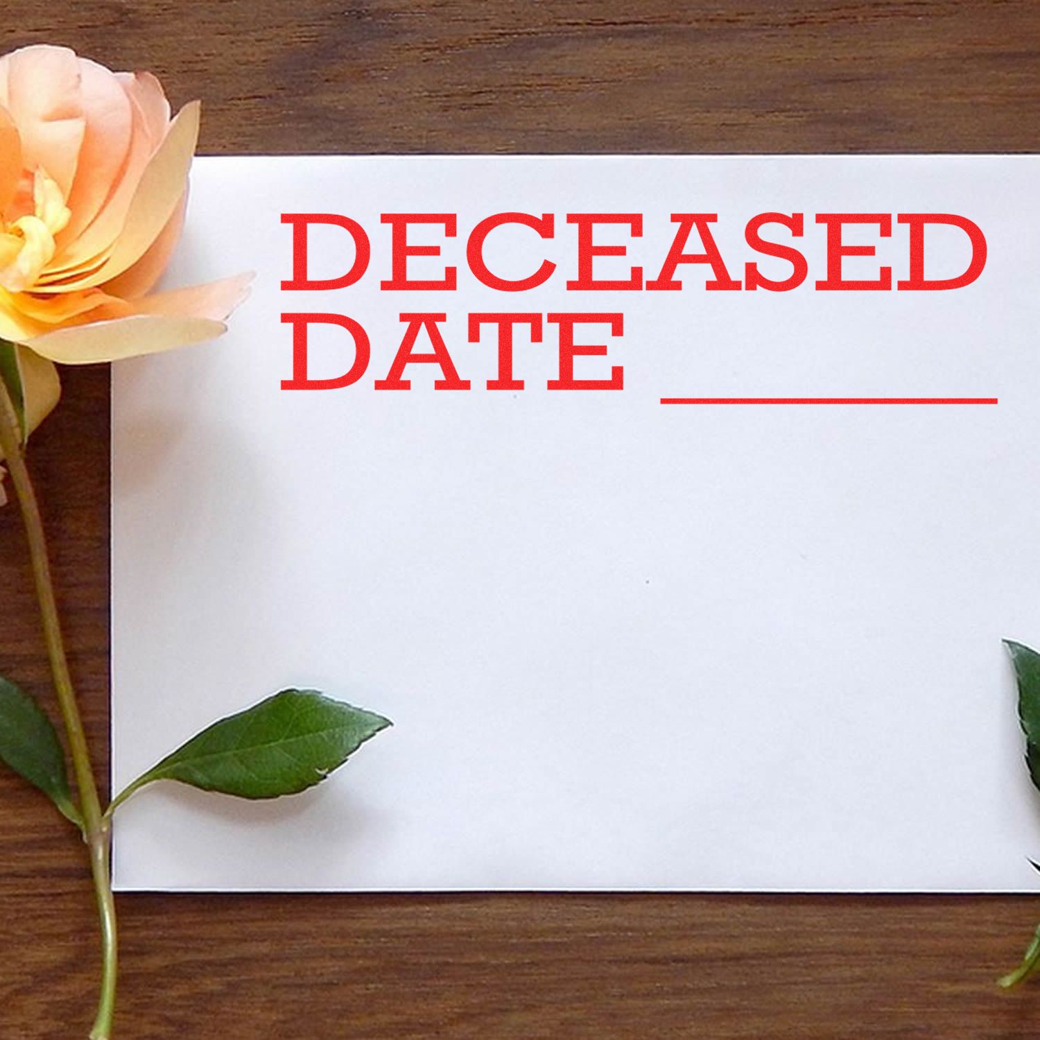 Blank deceased date card with flower on wooden table for funeral or memorial planning