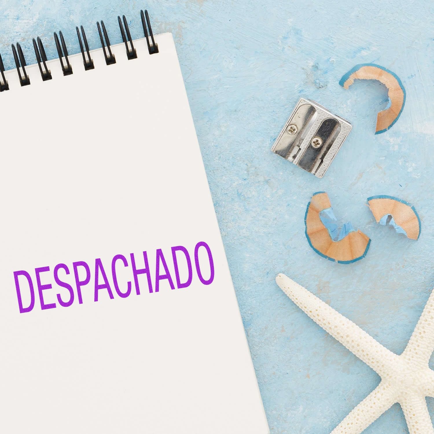 Despachado shipping label on white page with pushpins and starfish on blue ocean background