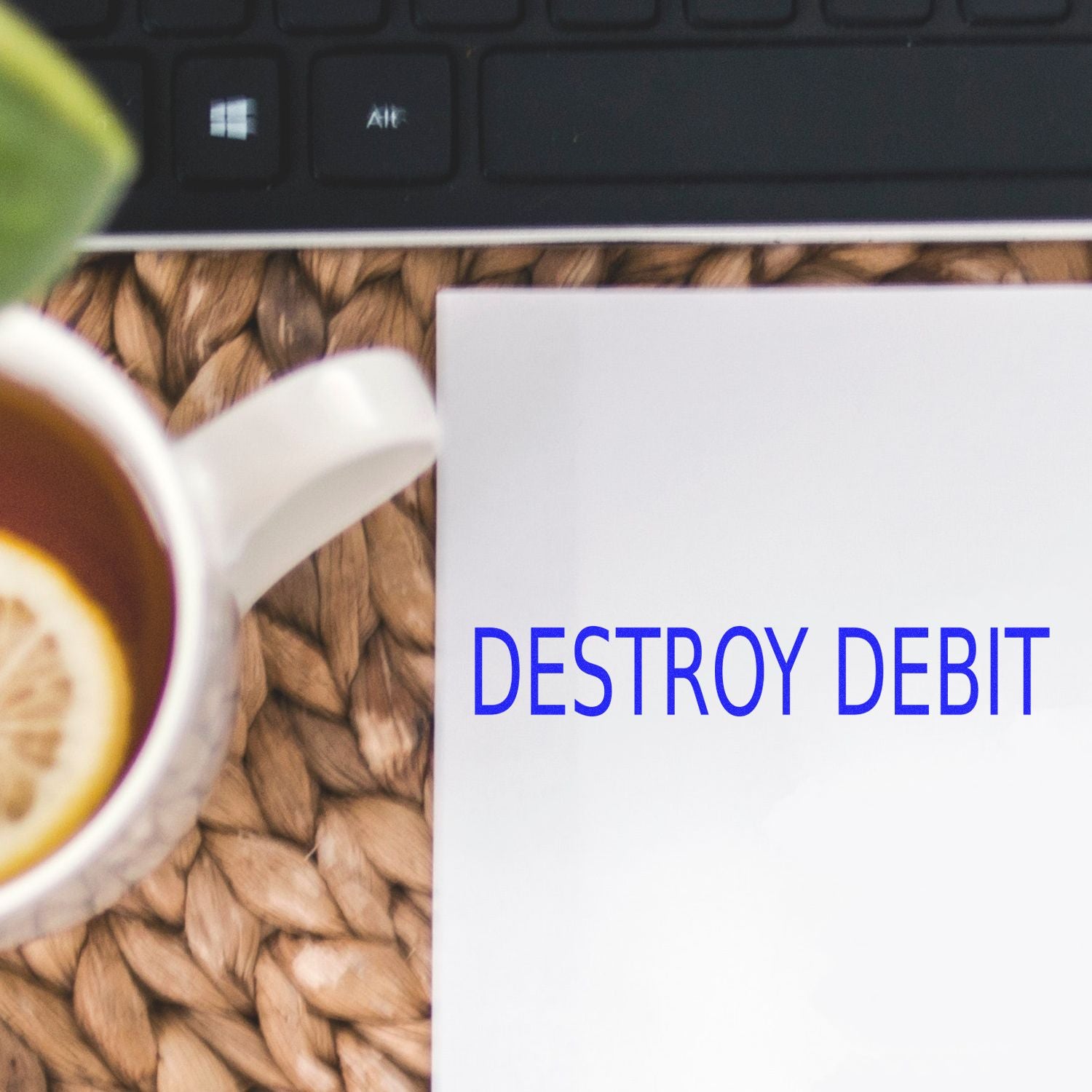 Calculator and paper reading Destroy Debt, promoting debt payoff and financial freedom message in a budgeting guide today.