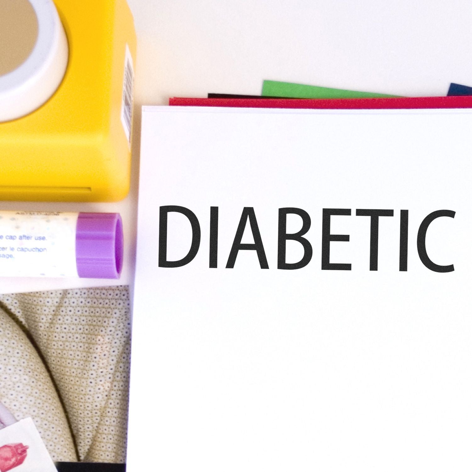 Diabetic medical supplies and diabetes awareness message DIABETIC on clean background, highlighting treatment and care kit essentials.