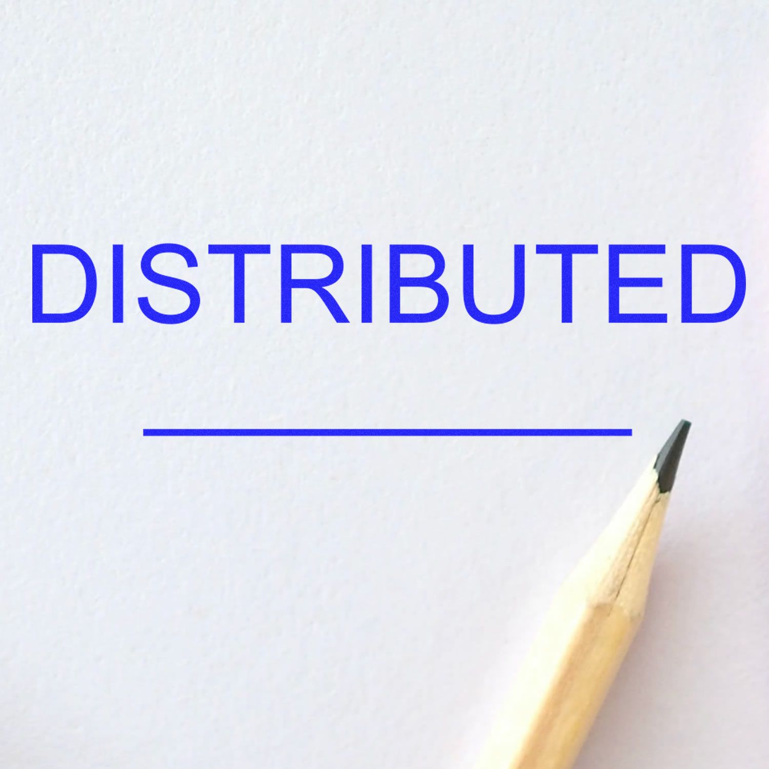 Blue DISTRIBUTED text on white paper with pencil tip, concept of distributed systems and document editing.