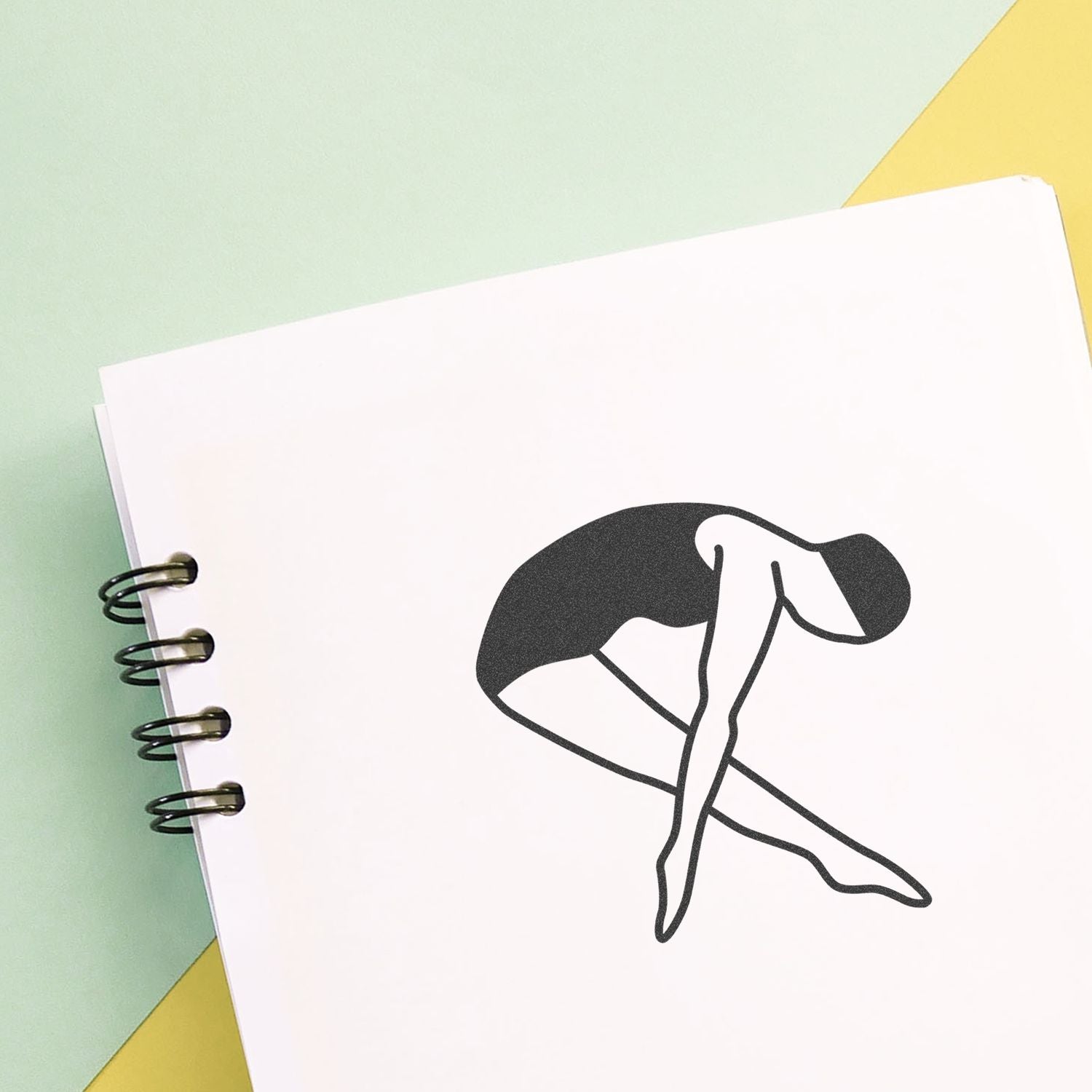 Minimalist yoga stretching illustration on a spiral notebook with pastel background.