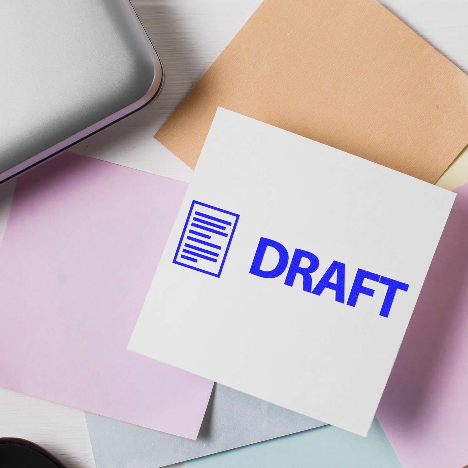 Draft document on colorful stationery beside a laptop, concept of business writing and editing.